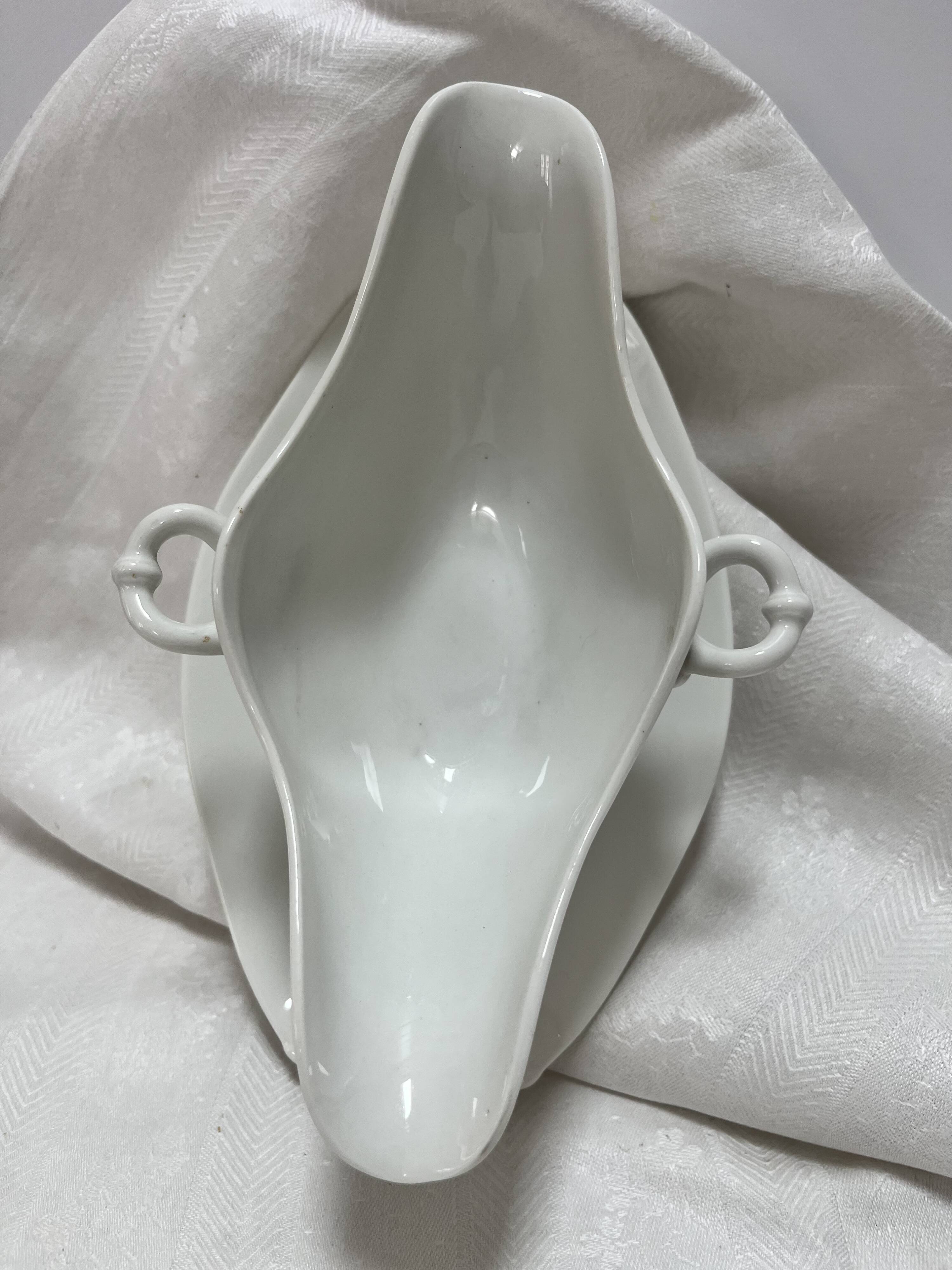 White porcelain sauce boat on tray