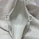 White porcelain sauce boat on tray