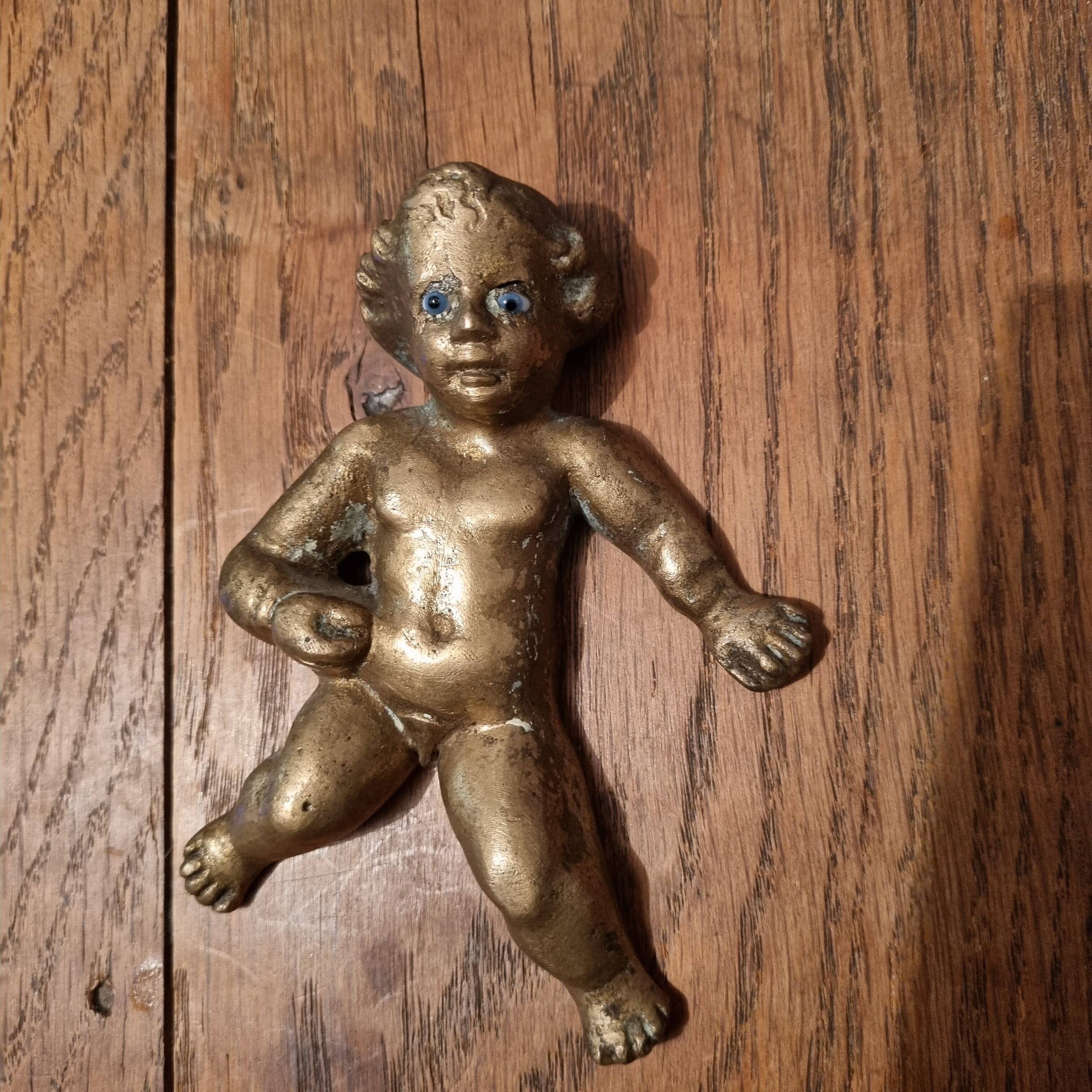 Rare bronze child statuette with blue eyes