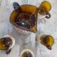 Carafe and glasses in amber glass and rattan