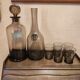 Table service set with a carafe, bottle, and 5 glass cups.