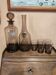 Table service set with a carafe, bottle, and 5 glass cups.