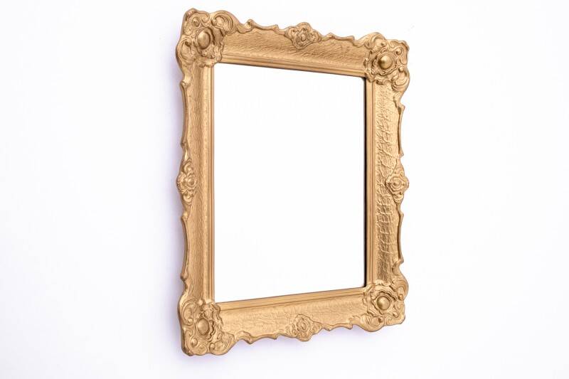 Mirror in a decorative gold frame