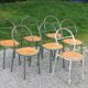 Set of 7 metal chairs by René Herbst with wooden seats.