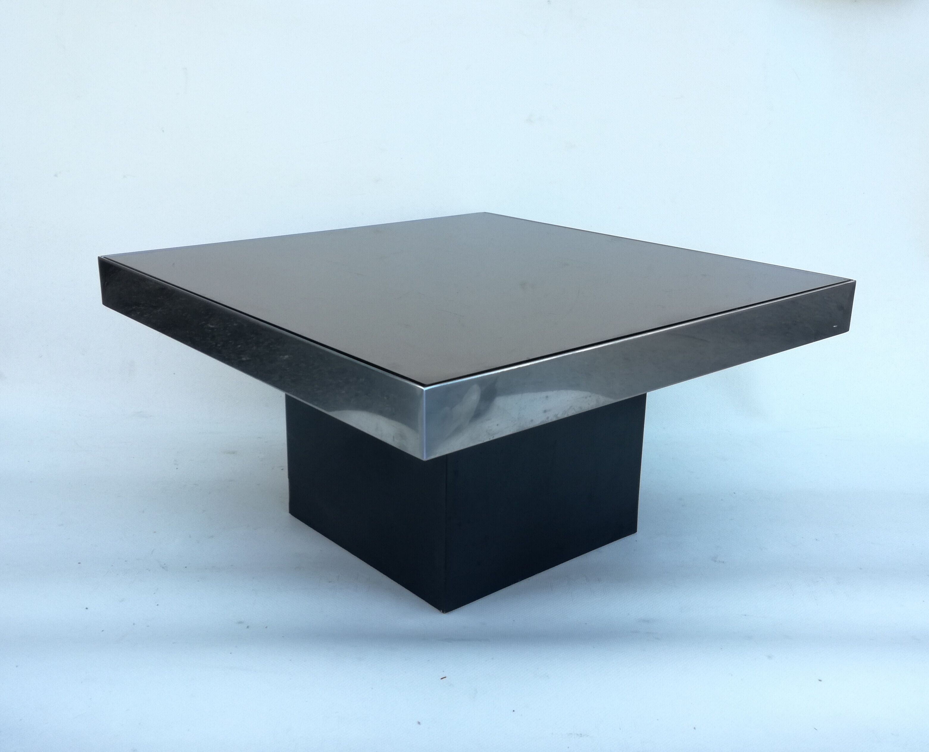 Square pedestal coffee table with mirror top