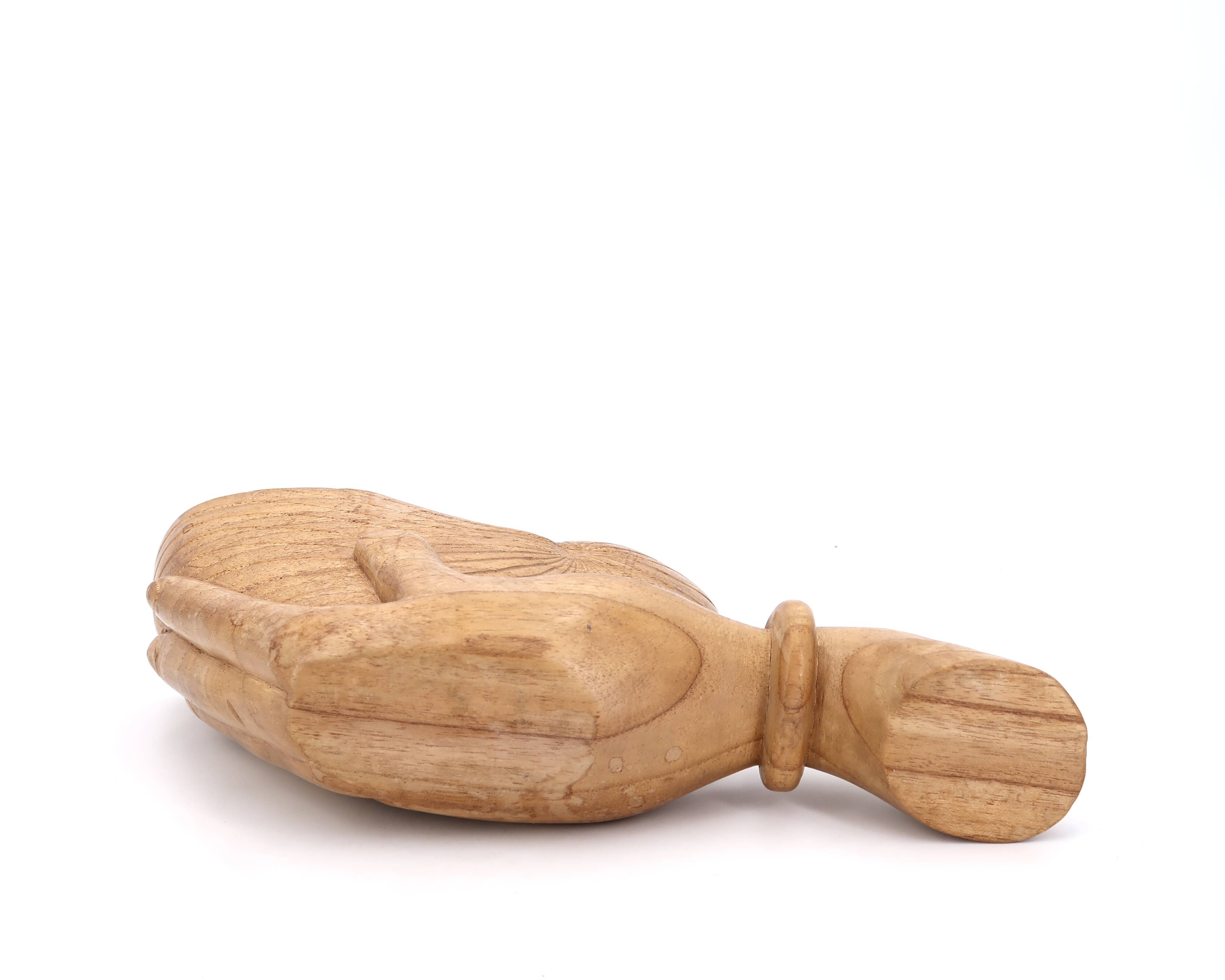 Wooden hand emptier holding a shell, 1970s