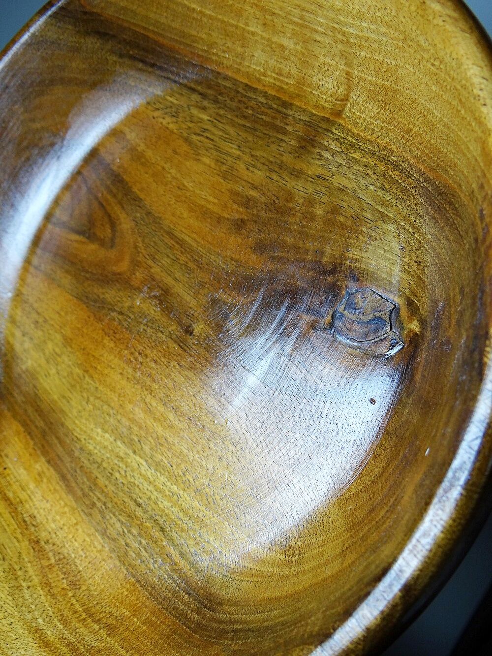 Teak or acacia wood bowl, vintage craftsmanship from the 70s to 2000s.