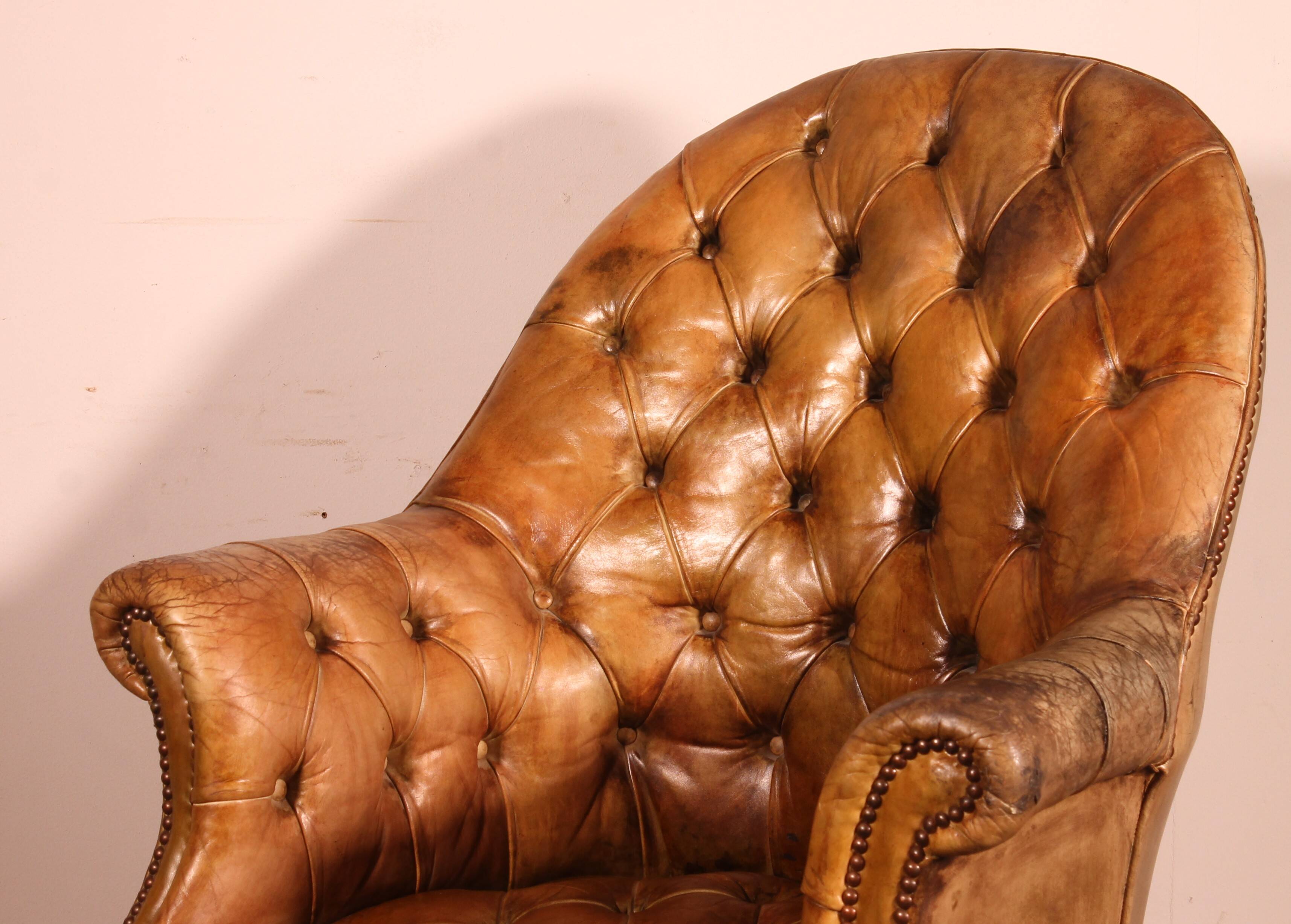 Office chair known as a presidential chair in mahogany and cognac leather.