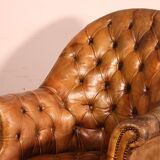 Office chair known as a presidential chair in mahogany and cognac leather.