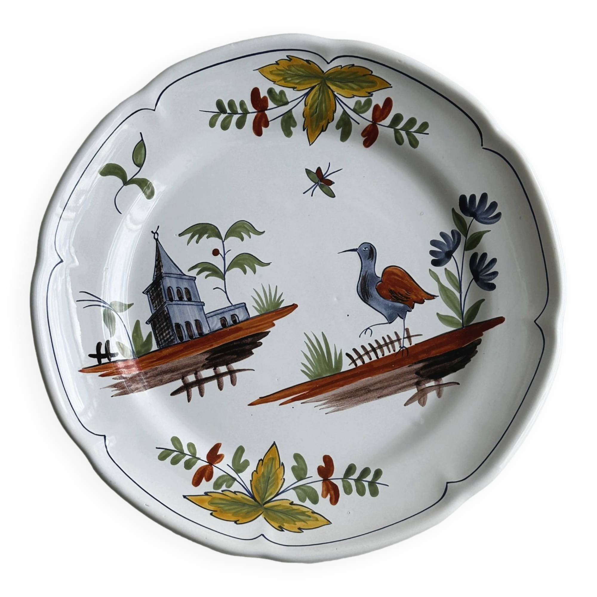 Hand-painted earthenware plate with landscape and bird decoration.
