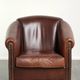Characterful sheepskin club armchair in a dark cognac colour in English style