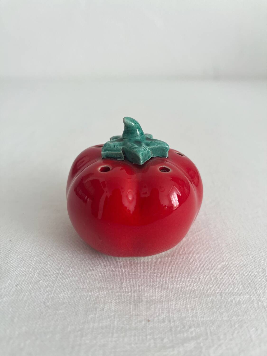 Vintage tomato salt or pepper shaker in slip