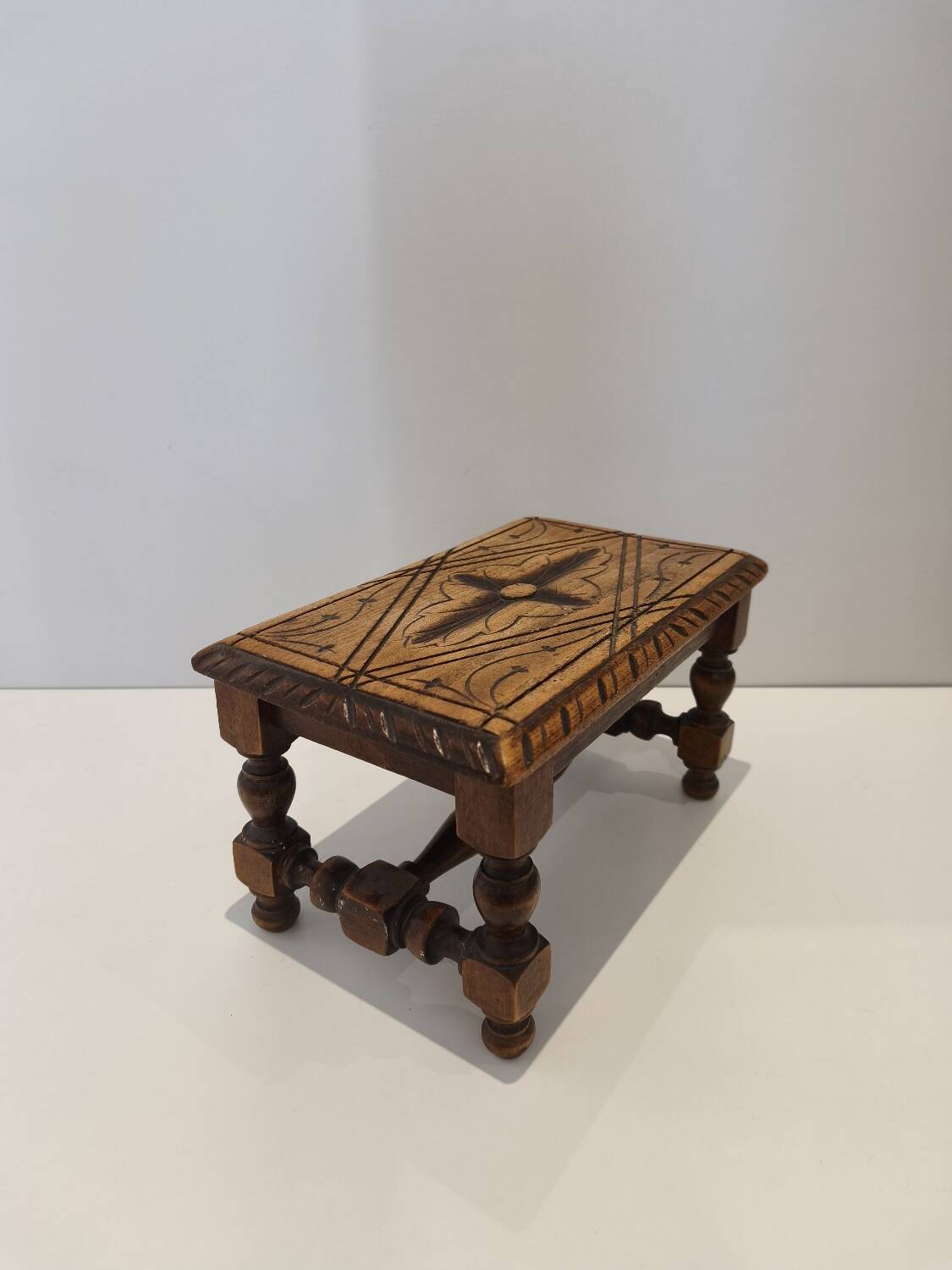 Small vintage carved solid wood footrest bench