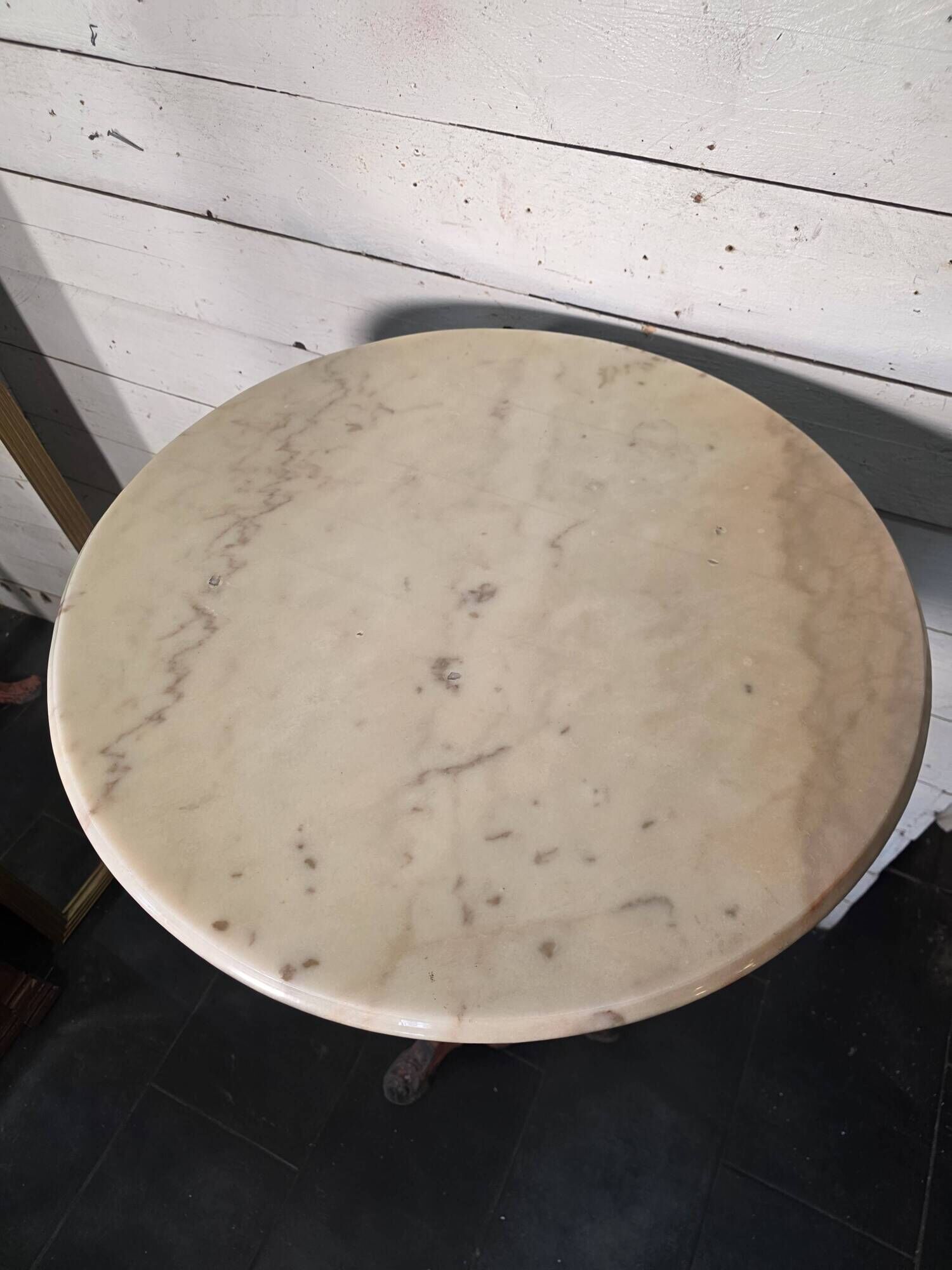 Bistro standing table with marble top and cast iron base.