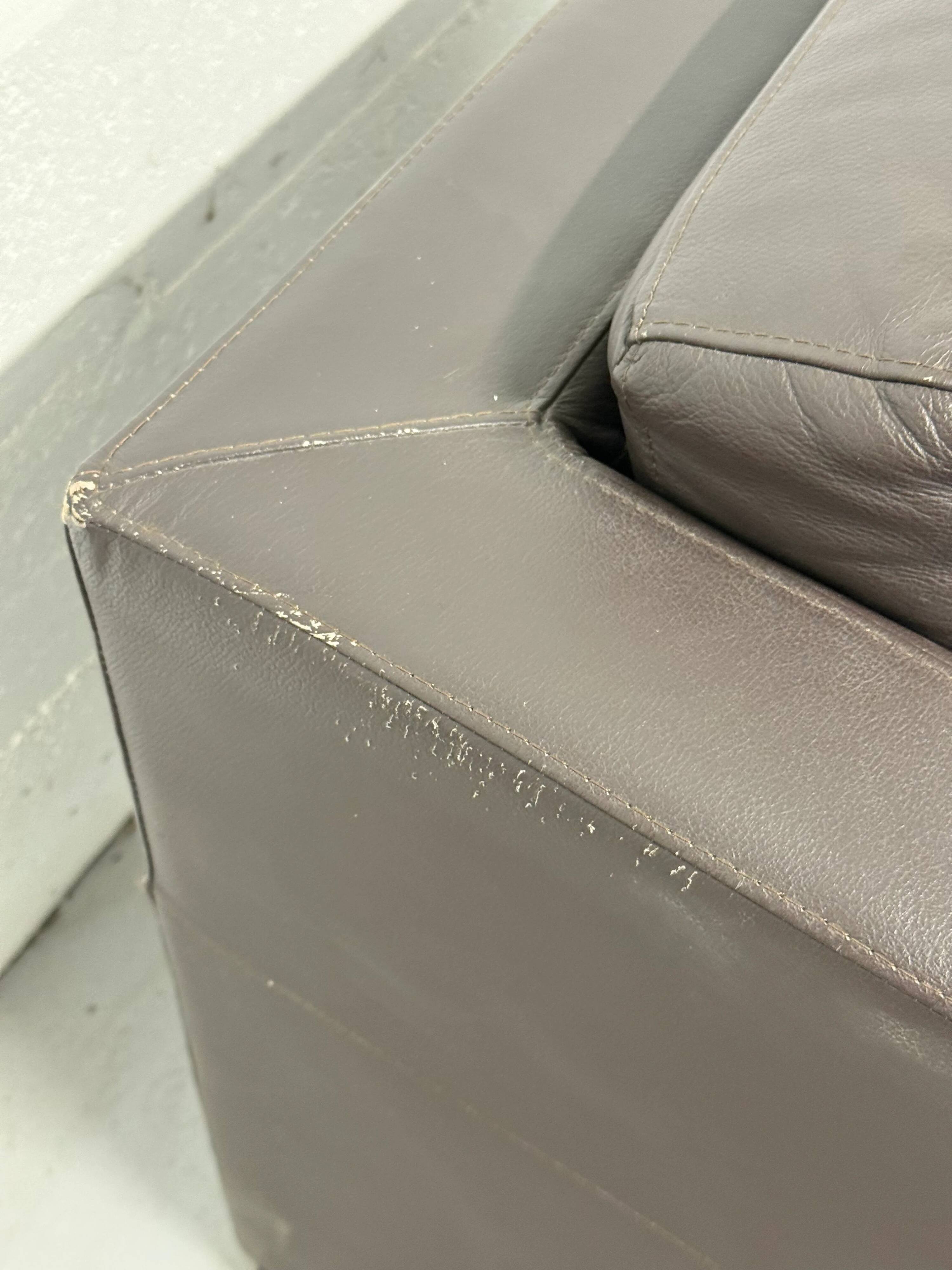 Vintage brown leather club armchair with a swivel side table.