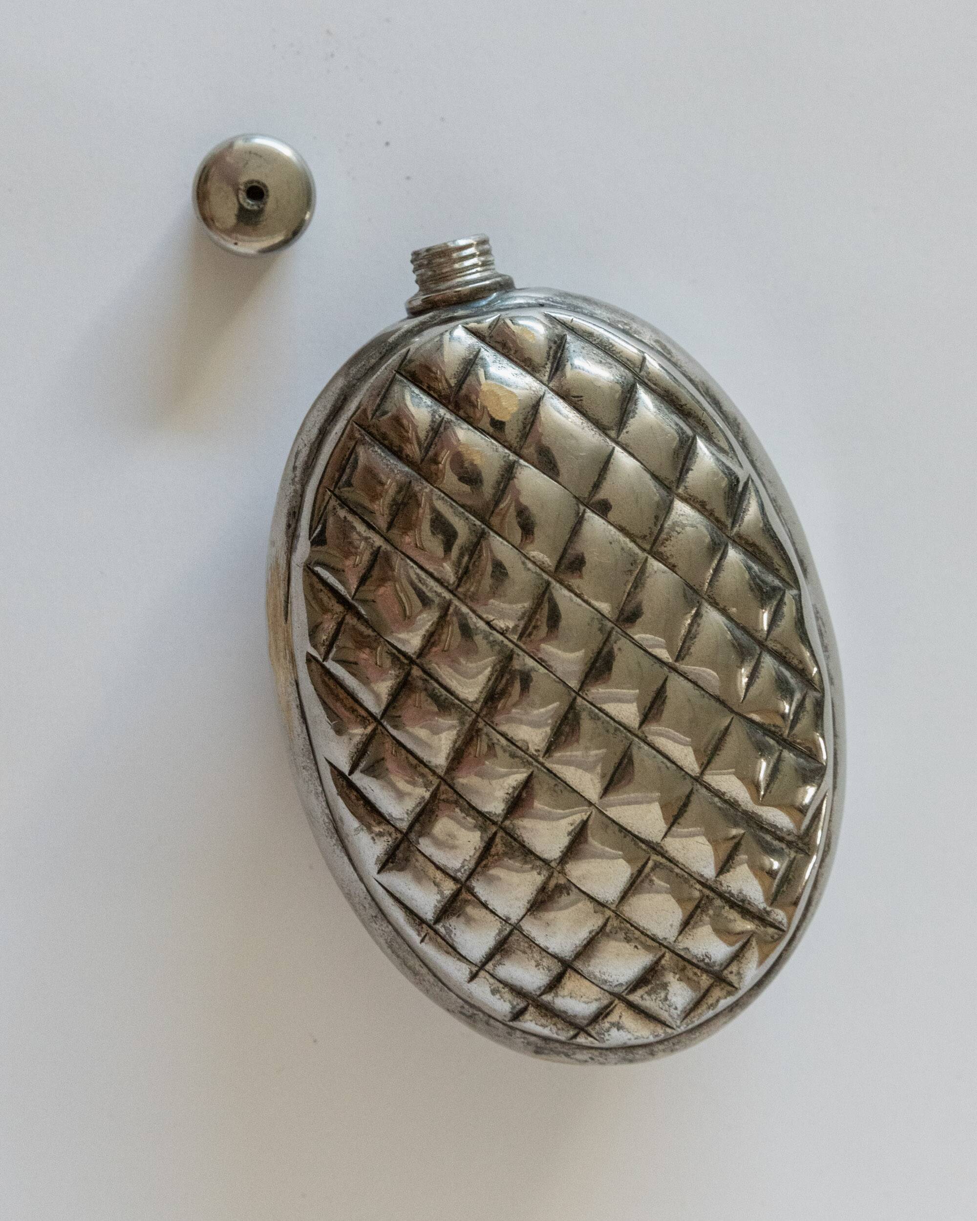 Vintage 1950s silver-plated flask in the shape of a pine cone.