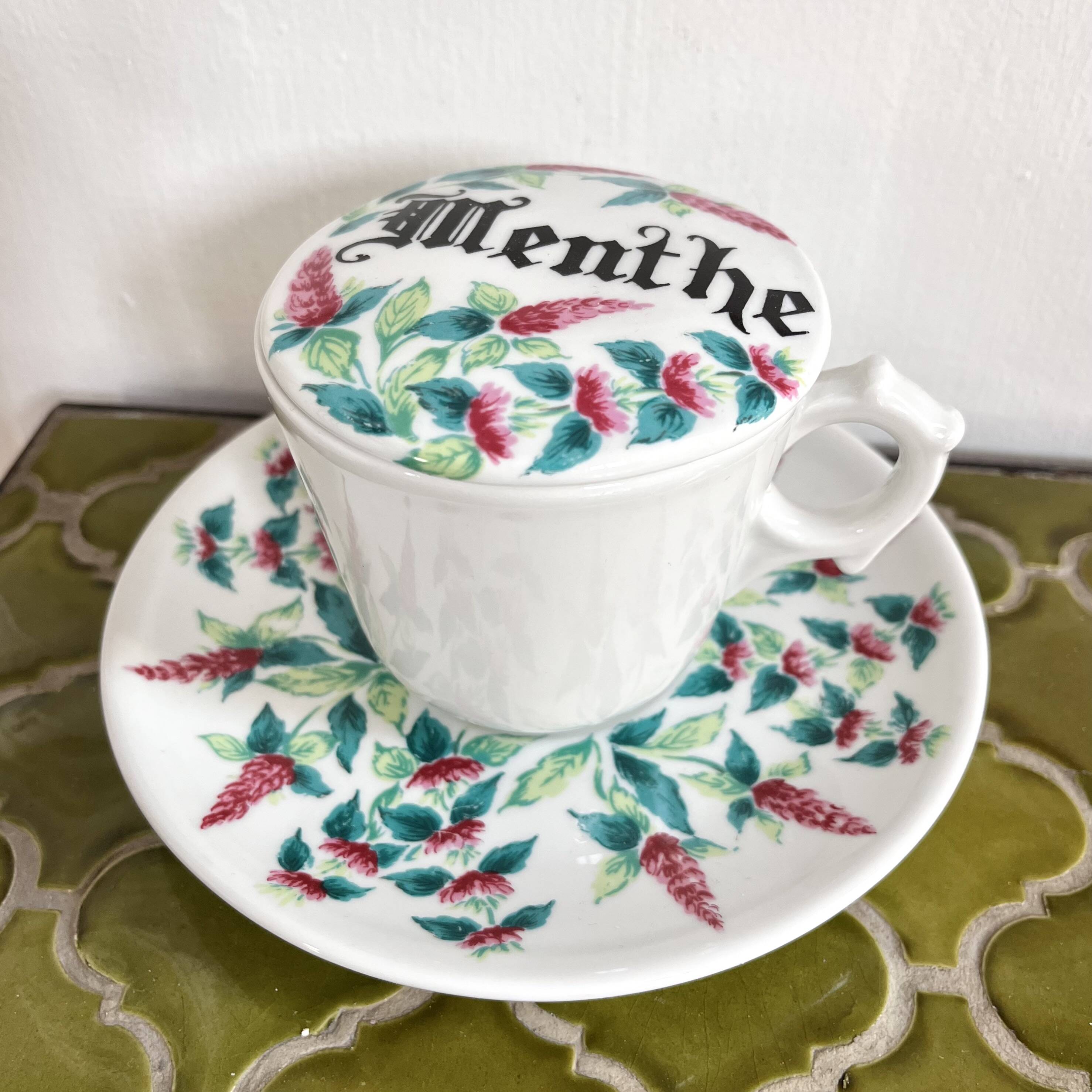 Antique herbal tea cup with mint infusion