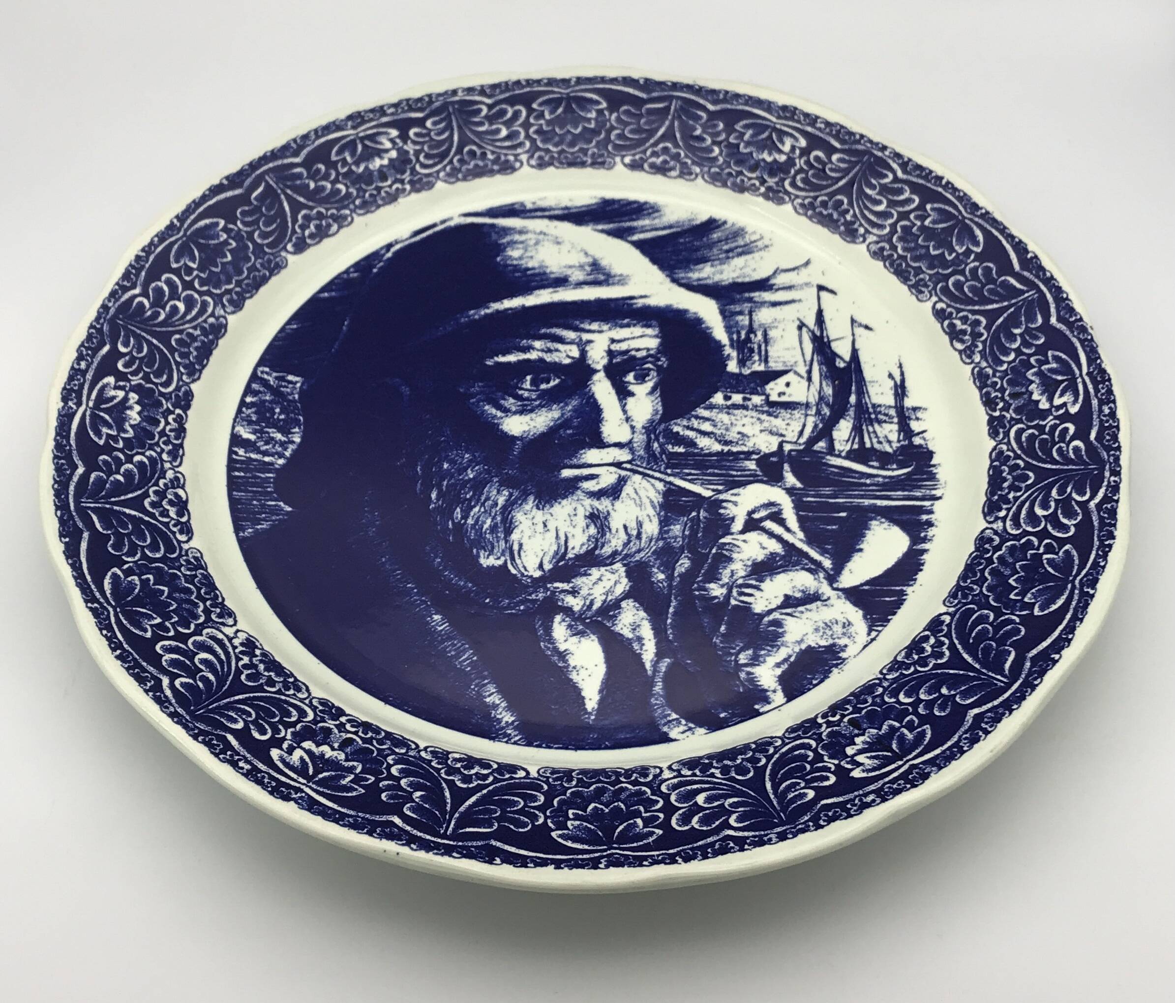 Blue enamelled earthenware wall plate with fisherman decor, Boch La Louvière, Belgium