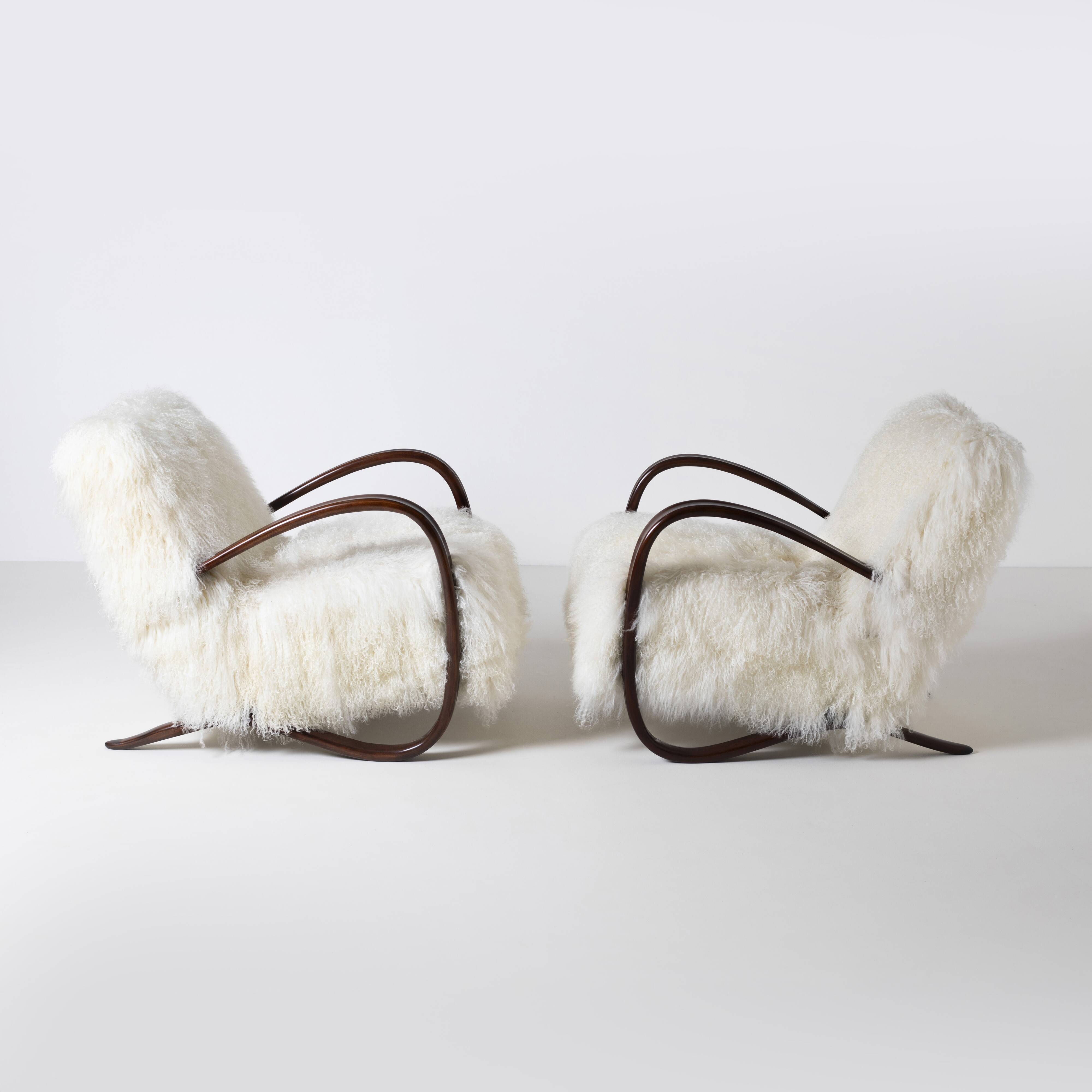 Pair of Jindrich Halabala H 269 lounge chairs in mongolian sheepskin