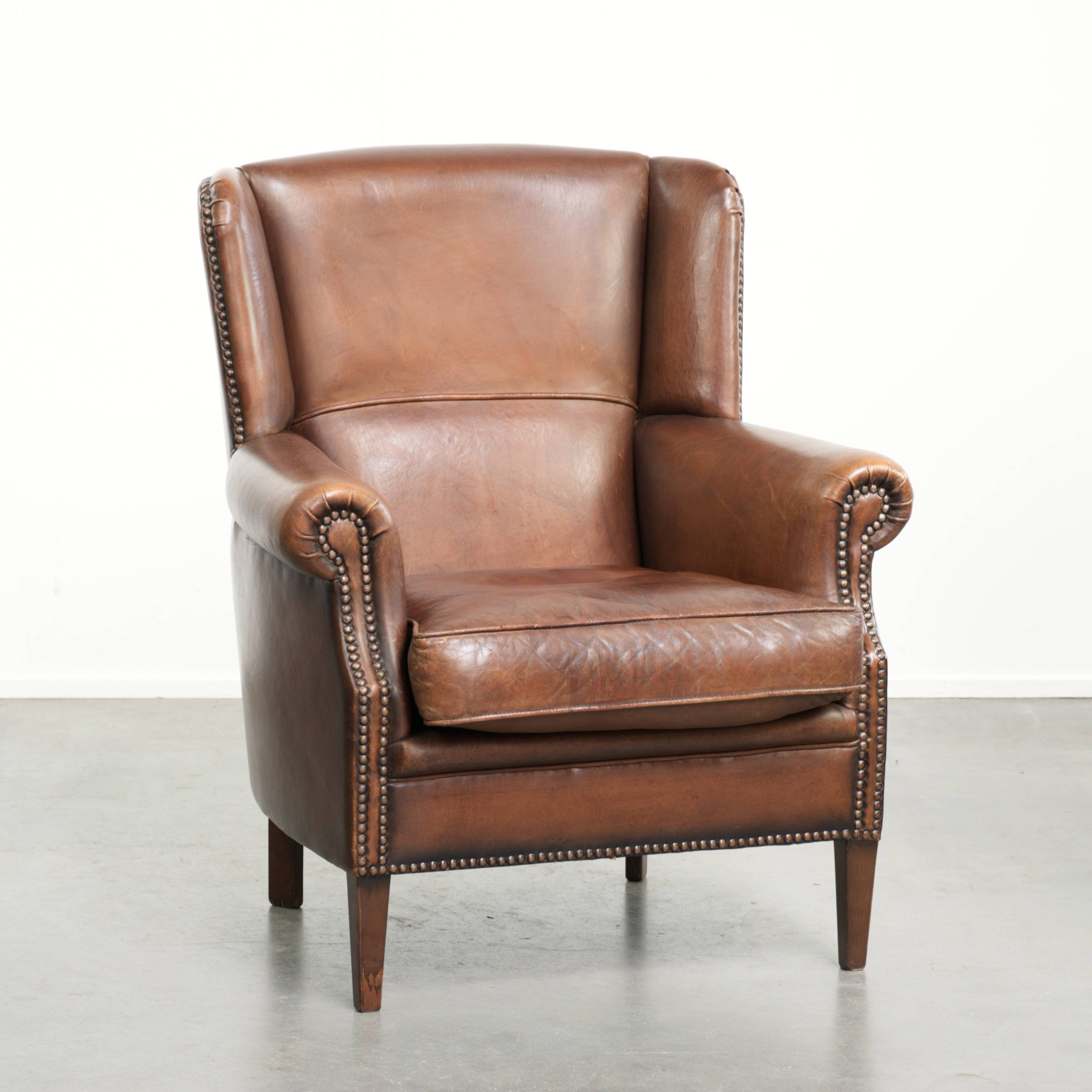 Subtle dark brown sheepskin wingback armchair with a timeless look subtle
