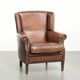 Subtle dark brown sheepskin wingback armchair with a timeless look subtle