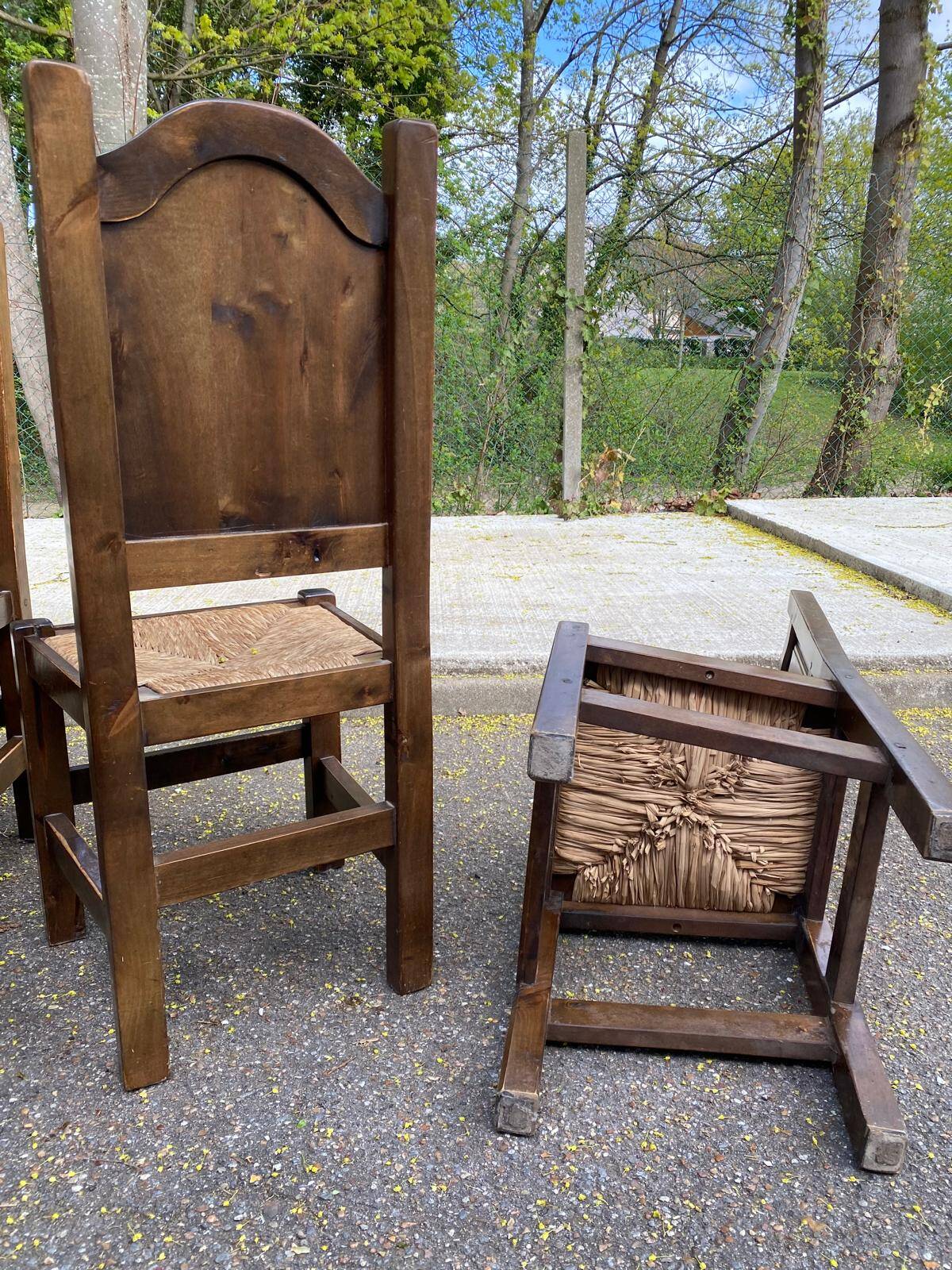 6 dining chairs in a country or farmhouse style, made of dark solid wood and rush-seated.