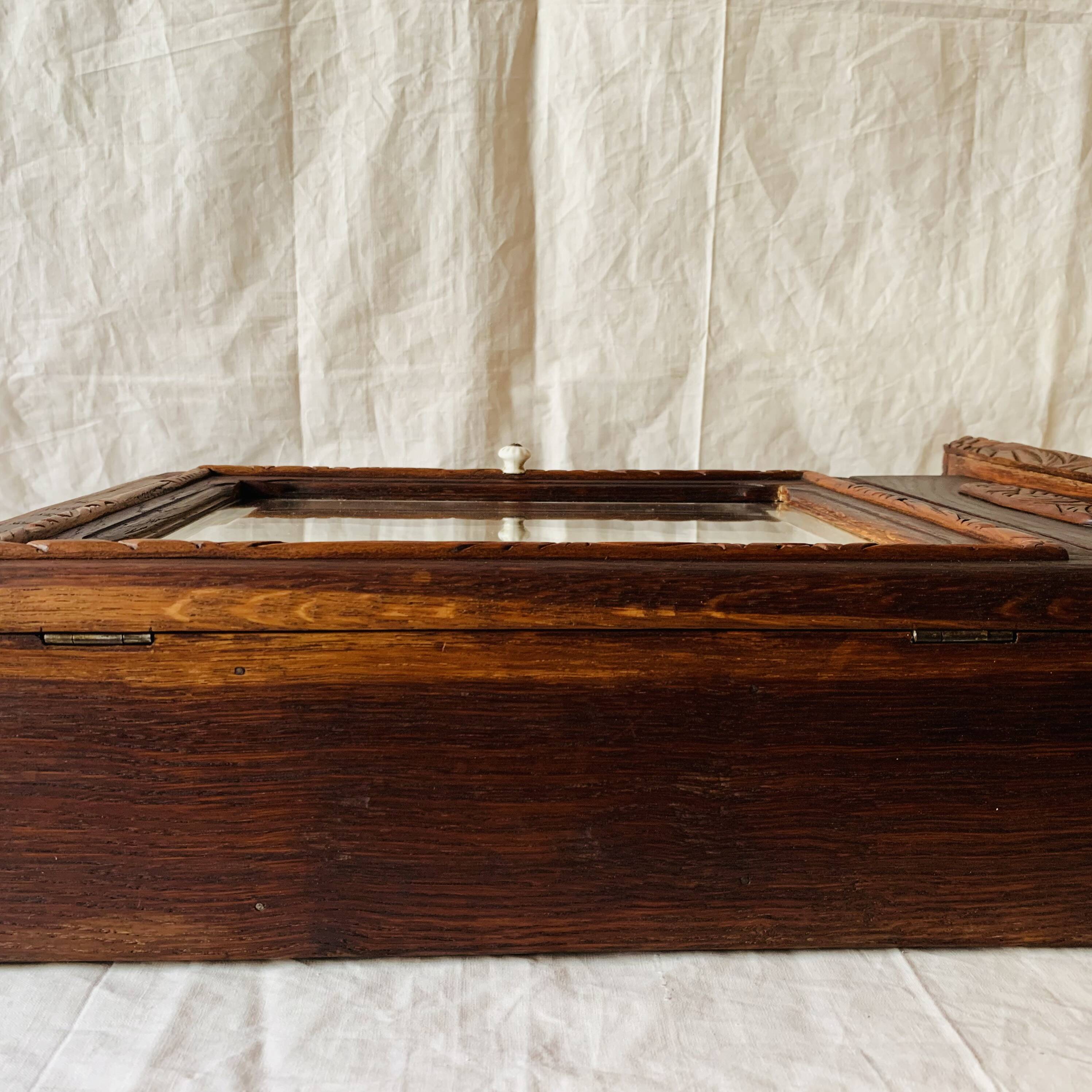 Old carved wooden medicine cabinet with beveled mirror