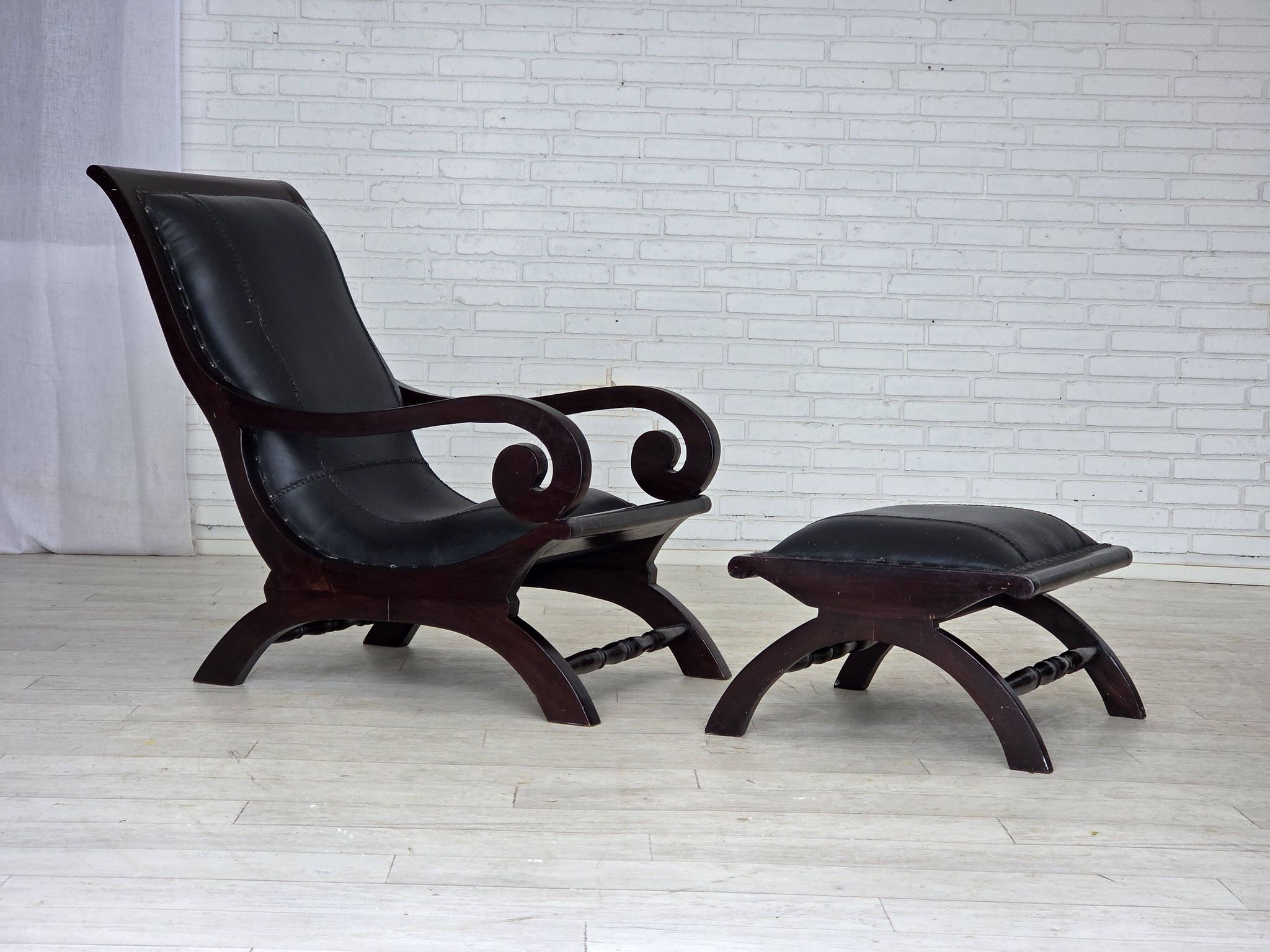 1970s, vintage armchair with footstool, black furniture leather.