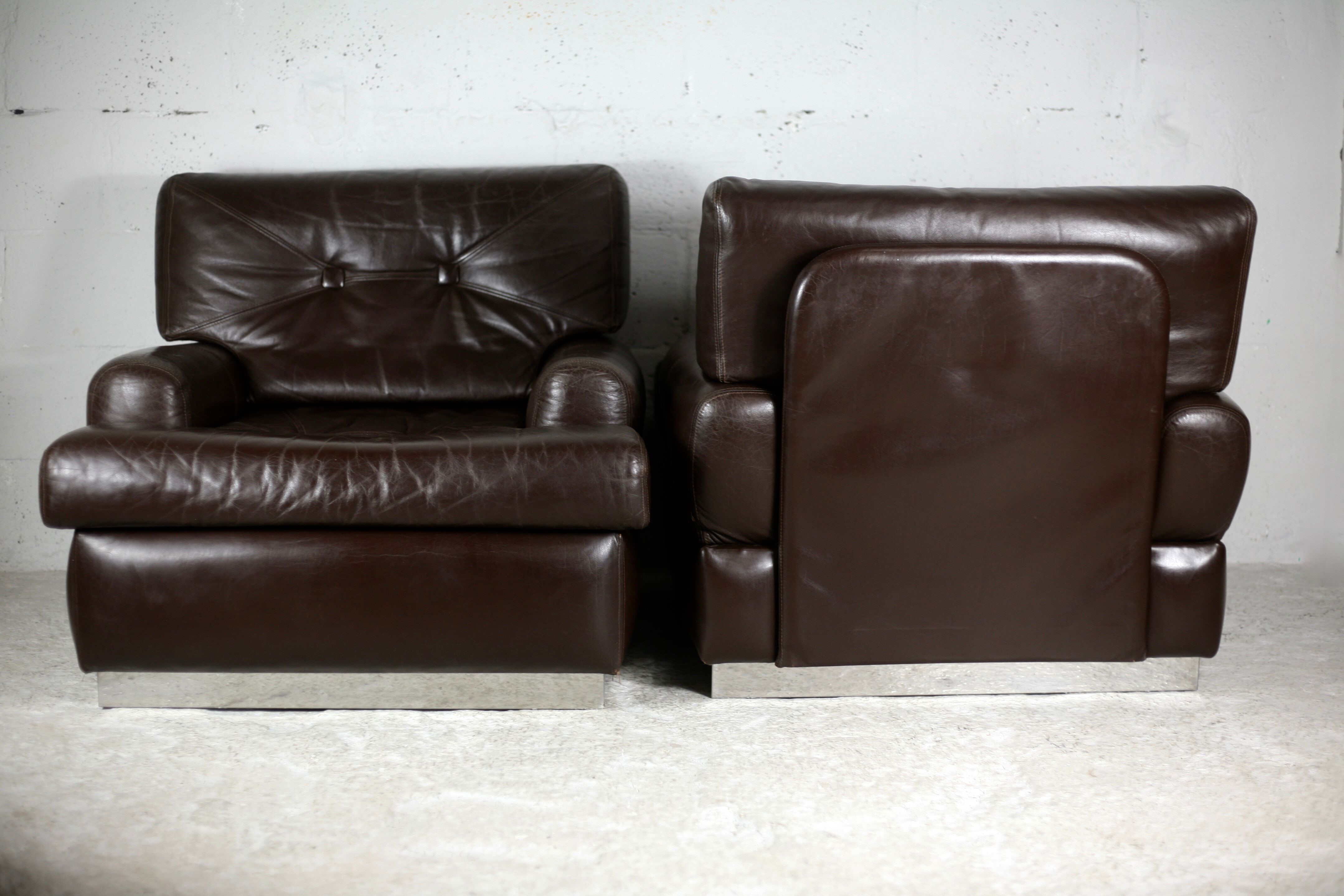 Pair of armchairs brown leather base stainless steel, France, circa 1970