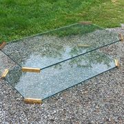 1970s designer coffee table in glass, plexiglass, and gold metal.