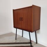 Piece of furniture on high feet metal compass