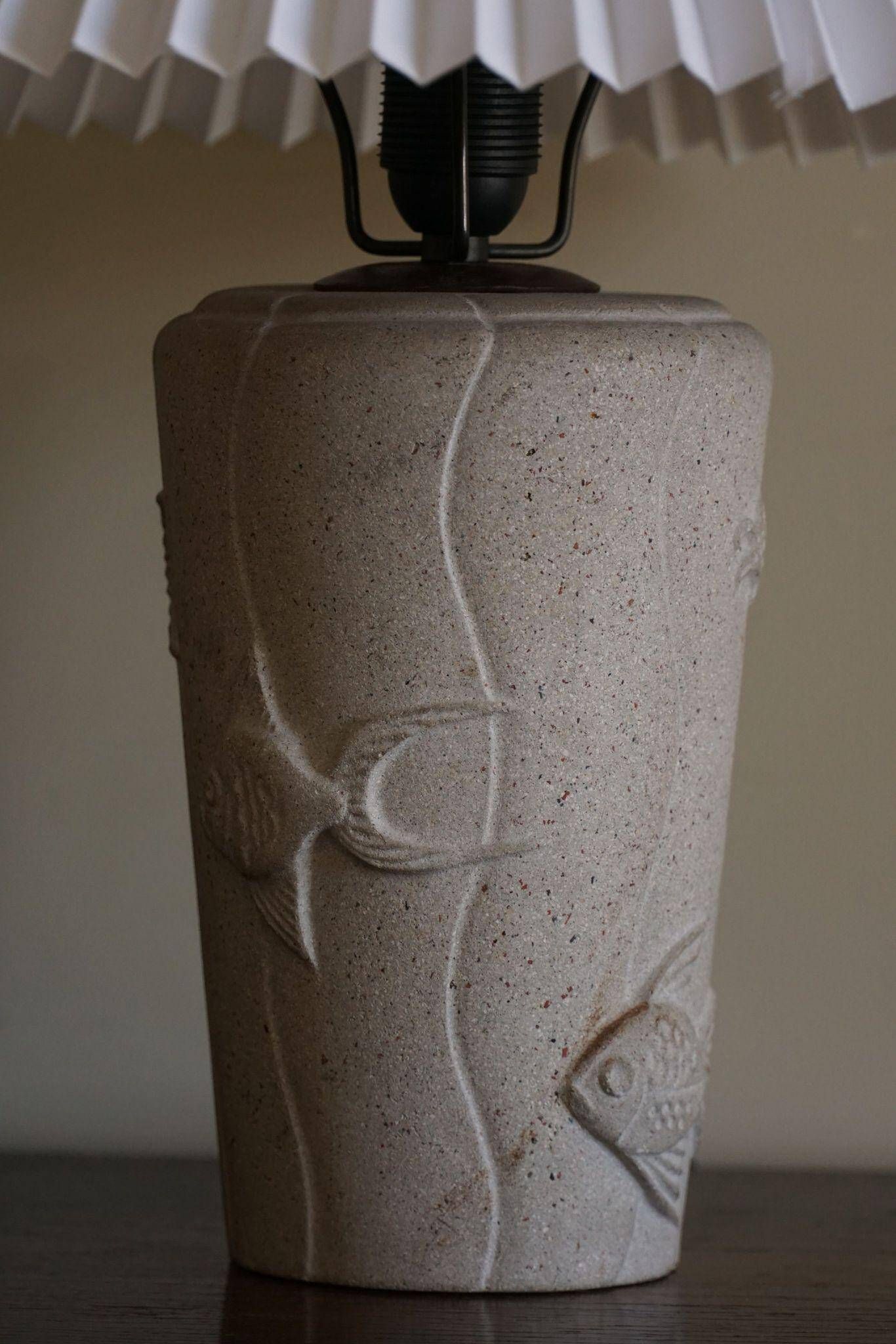 Modern vintage French table lamp, made of stone with fish patterns, 1970s.