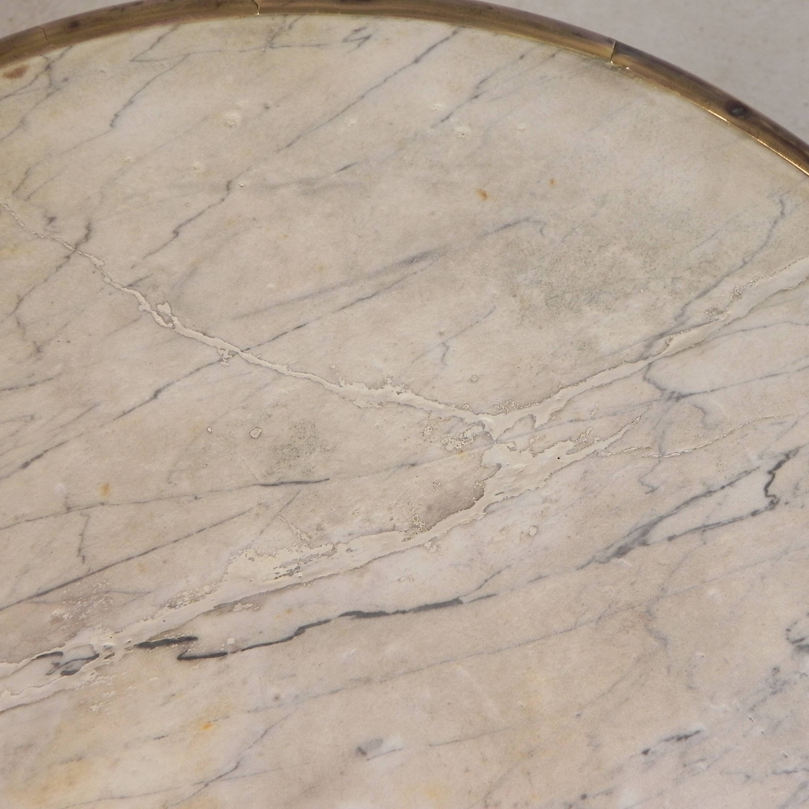 Bistro table with a marble top and brass edging, early 20th century.