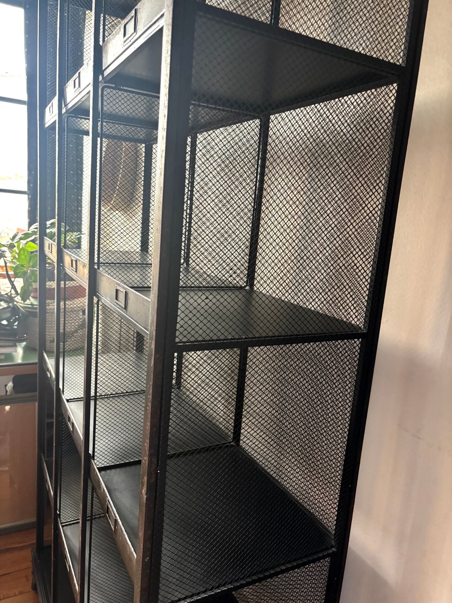 Black metal shelf with compartments.