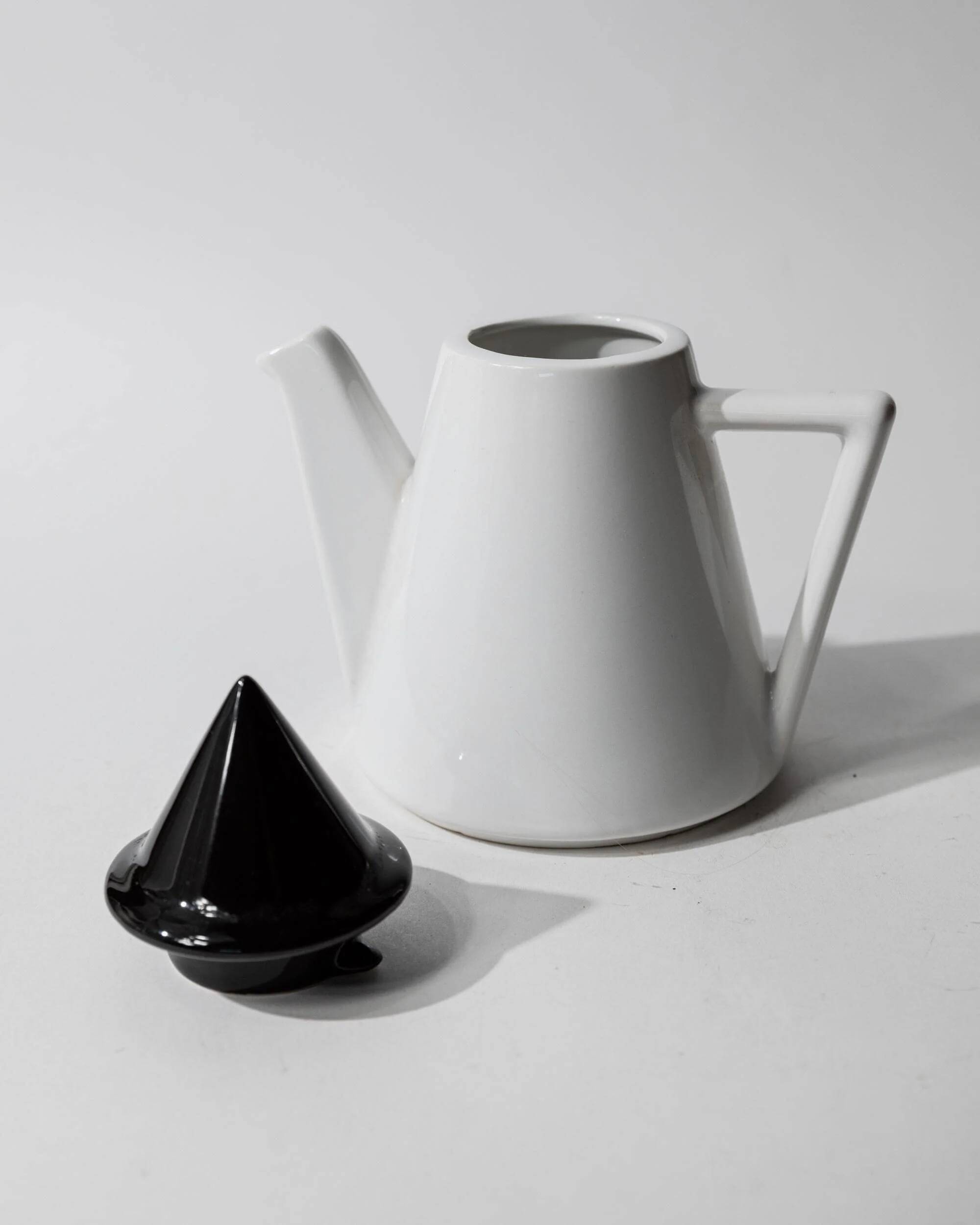 Vintage ceramic coffee pot or teapot from the 1980s, postmodern Memphis design, black and white triangles.