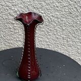 Burgundy red blown glass vase in the shape of a vintage corolla