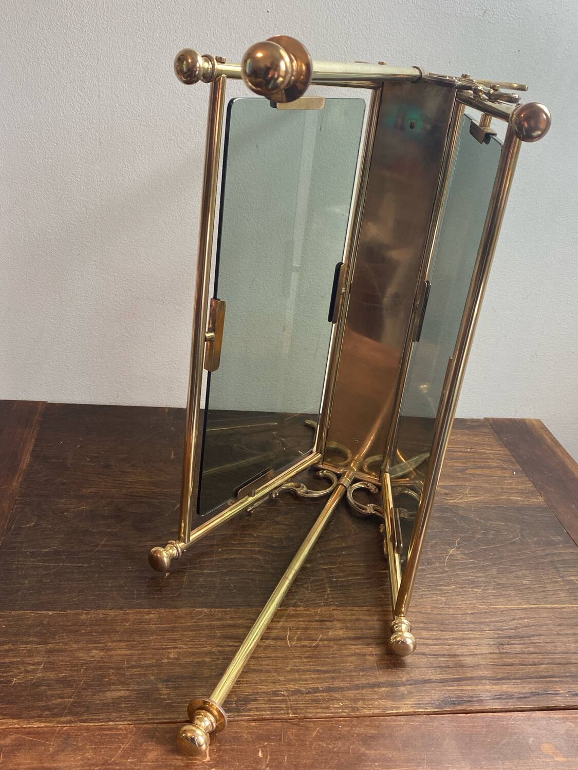 Brass magazine rack and blue-tinted glasses, 1950s.