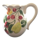Fruit-decorated pitcher in slipware