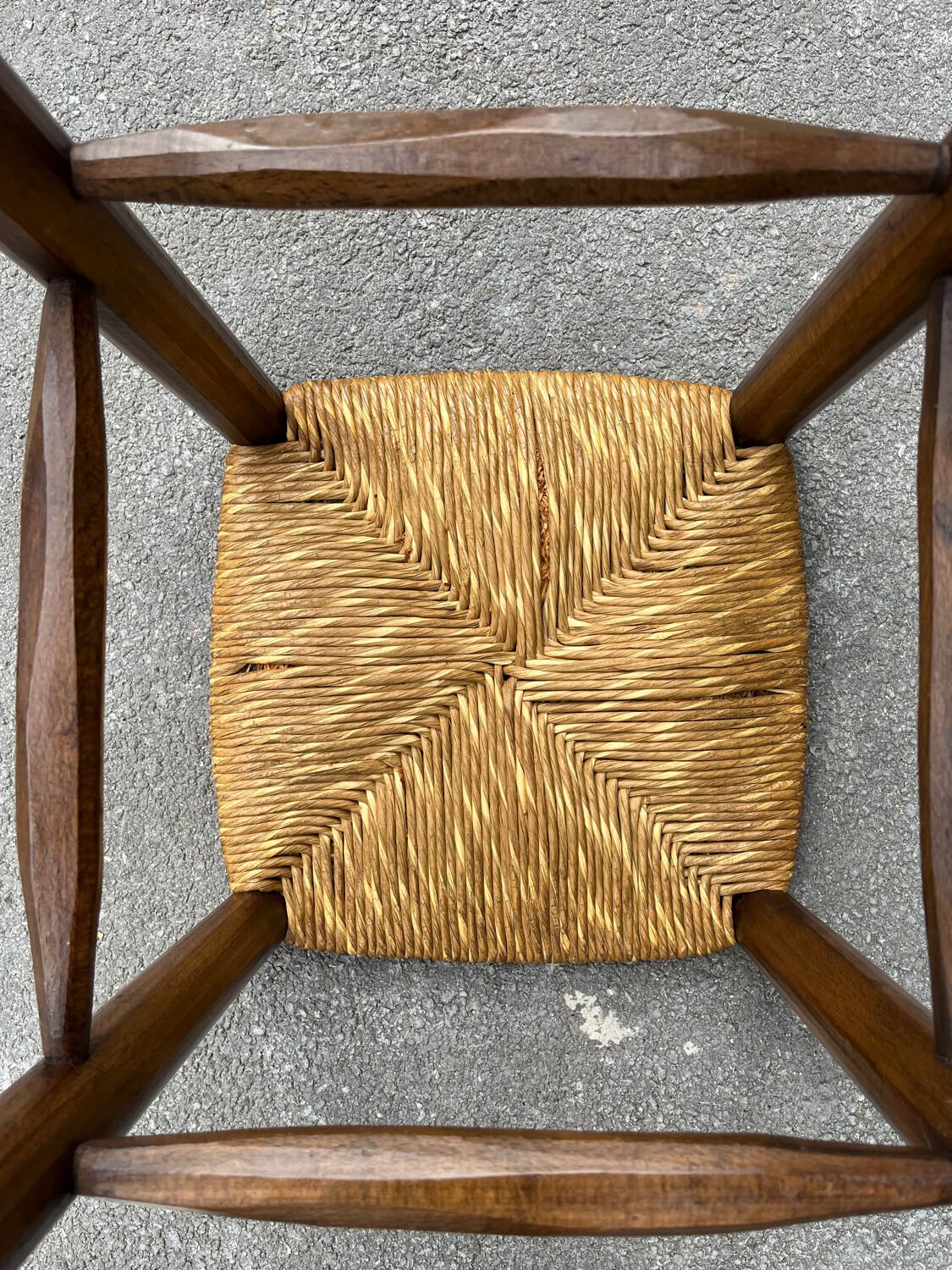 Old high bar stool in wood and straw