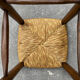 Old high bar stool in wood and straw