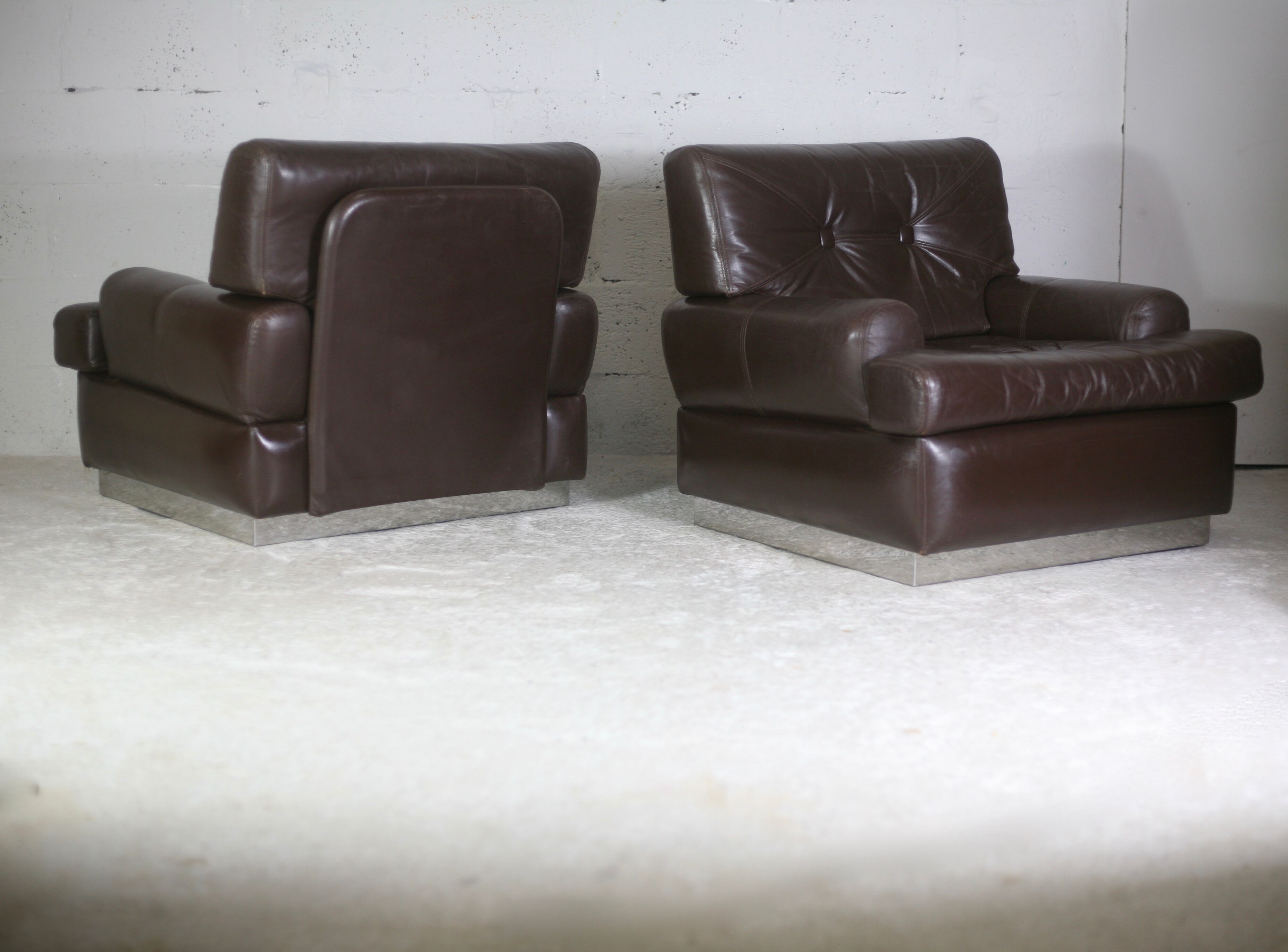 Pair of armchairs brown leather base stainless steel, France, circa 1970