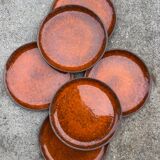 Orange glazed ceramic plates from the 1970s