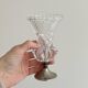 Small vase on a metal stand with thick glass.