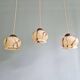 Trio of Art Deco marbled opaline pendant lights, 1920-30