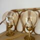 2 bedside lamps with round amber glass globes and gold metal.