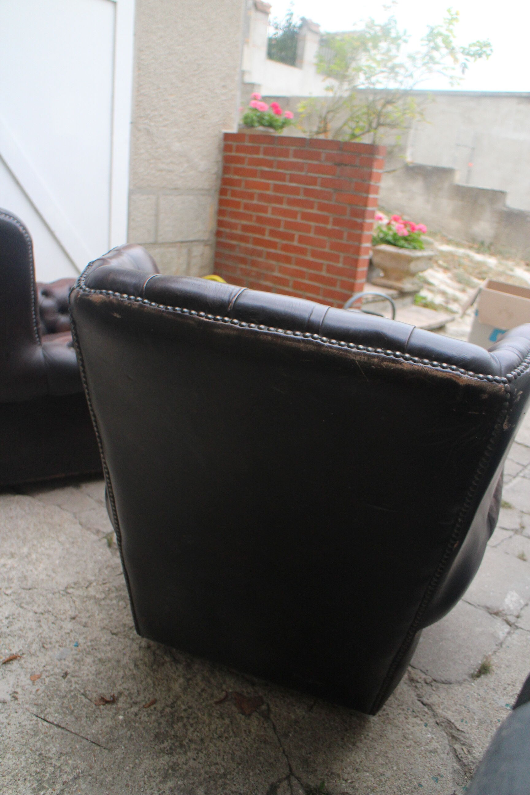 Padded chesterfield leather armchairs