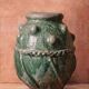 Glazed terracotta urn with protrusions and cordons.