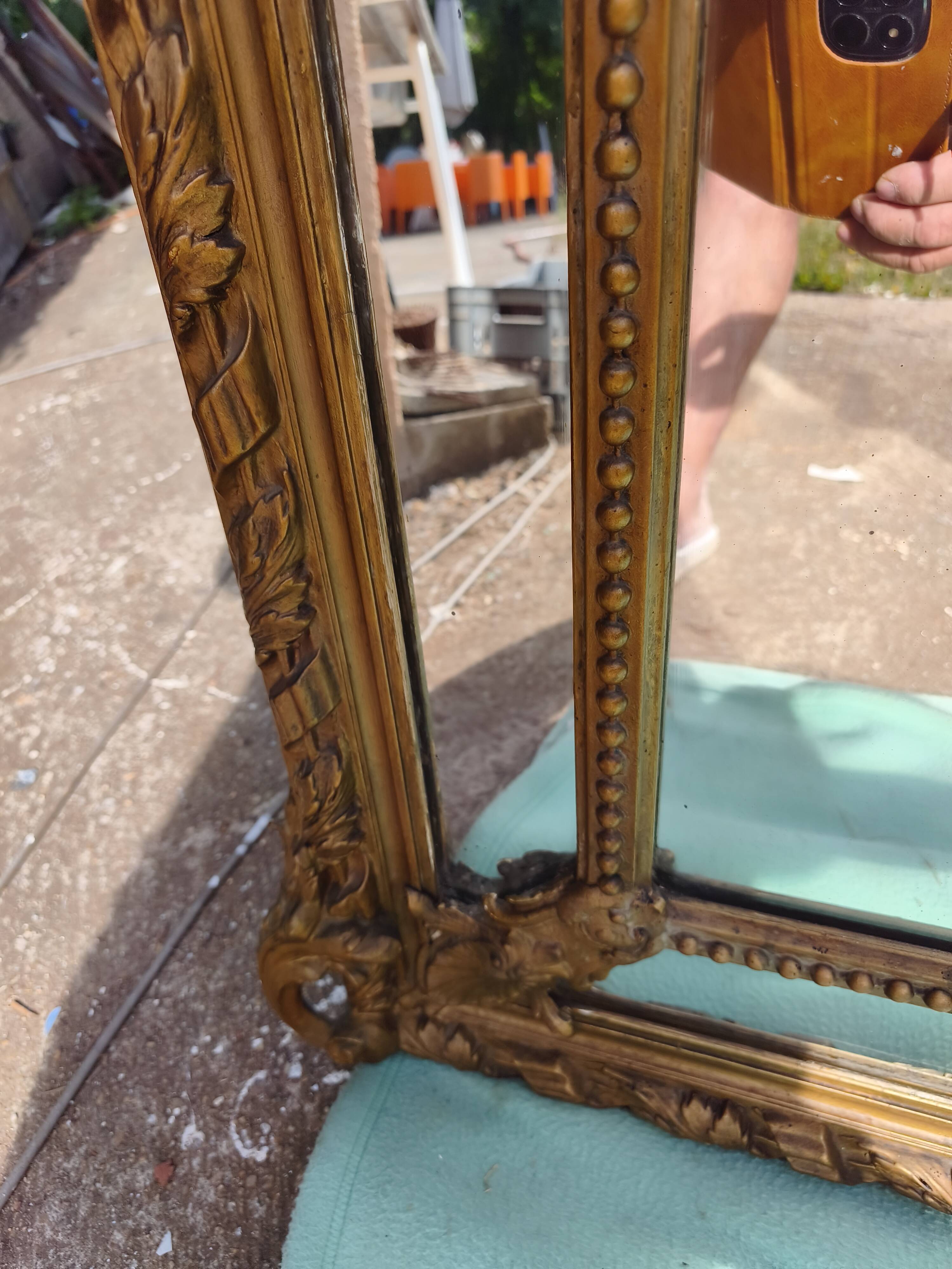 Large closed mirror, 19th century, wood and gilded stucco.