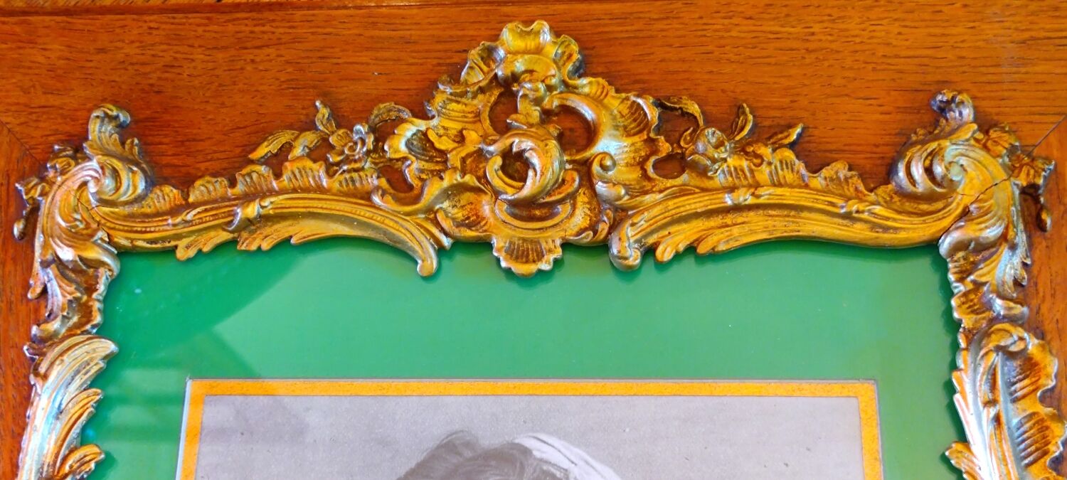 Old wooden frame and bronze ornament