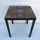 Old black metal and majolica tiles table